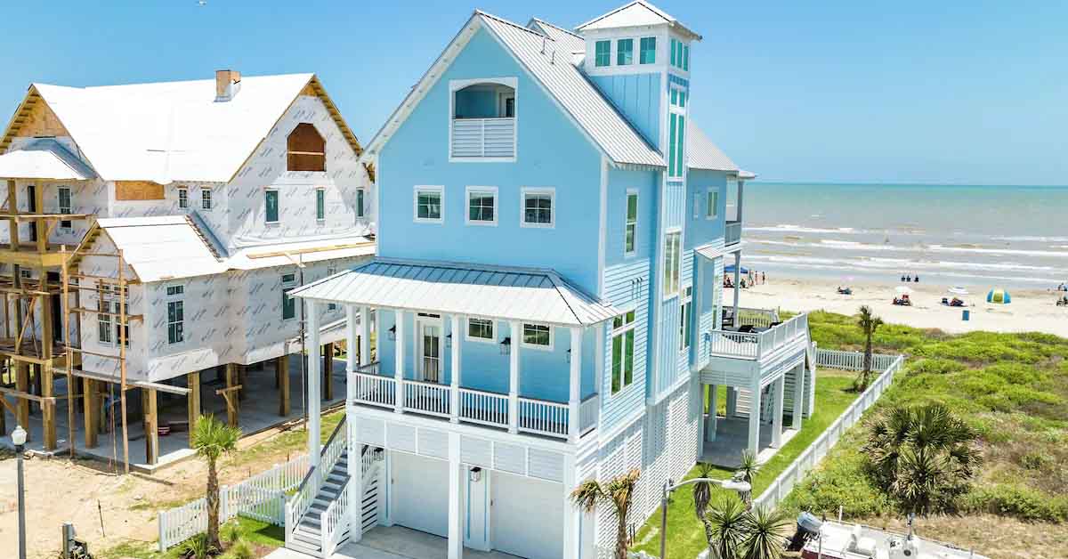 Modern home with large windows facing the ocean.